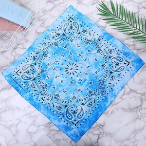 Close-up of blue paisley cotton bandana featuring 100% cotton fabric and fine stitching