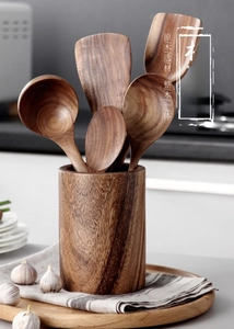 Detailed view of handcrafted acacia wood kitchen utensil set with storage holder
