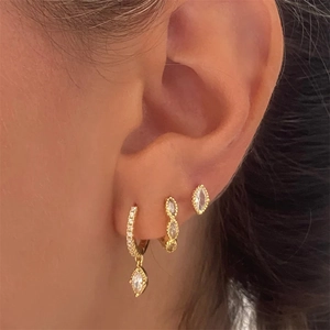 Detailed close-up of gold S925 silver hoop earrings with white zircon on ear model