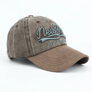 Detail view of the heavy washed cotton texture and 3D New York embroidery on the baseball cap