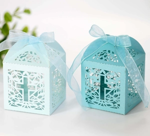 Laser-cut pearl blue candy boxes with cross hollow patterns and elegant organza ribbons