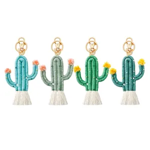 Set of four handmade bohemian cactus keychains with colorful pom poms and white tassels