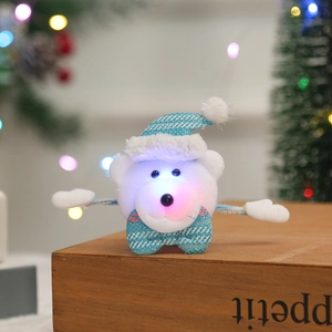Close-up of glowing plush bear Christmas wristband on rustic wood with bokeh lights