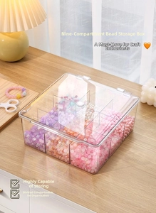 Macro shot of 9-compartment clear acrylic storage box filled with colorful beads