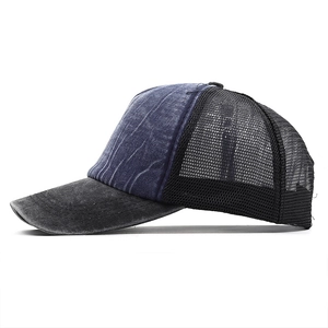 Detail view of washed denim baseball cap with breathable black mesh and curved brim
