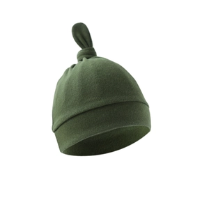 Close-up of olive green newborn knotted cotton hat featuring top twist and rolled edge