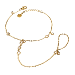 Gold stainless steel ring bracelet with multiple sparkling cubic zirconia on white background