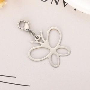Detailed view of a silver hollow butterfly charm with a secure lobster clasp attachment