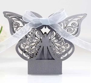 Detailed laser-cut hollow butterfly wedding favor box in grey paper with ribbon bow