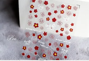 Close-up of TS-432 red flower nail stickers with artistic floral patterns and text