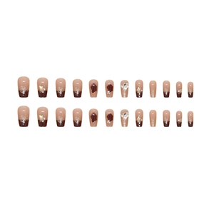Long trapezoidal press-on nails with brown gradient, white snowflakes and 3D rhinestones
