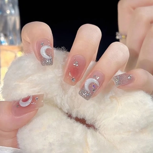 Pink and grey gradient press-on nails with silver moon charms and glitter accents