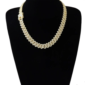 Detail of 14mm gold-plated cuban link necklace with iced out pavé set rhinestones