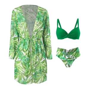 Detailed view of women's 3-piece swimwear with green tropical palm leaf print and cover-up