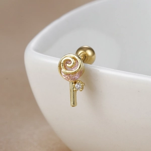 Macro view of lollipop stud earring in 18K gold stainless steel with pink swirl gem