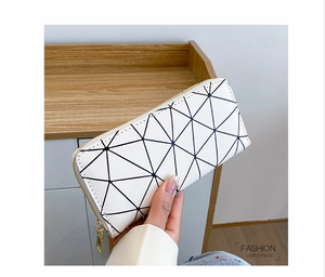 Fashion lady long white wallet with geometric pattern and gold zipper held by model