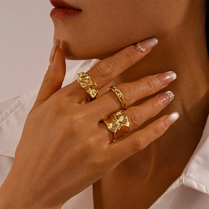 Macro shot of gold lava-textured adjustable rings set on hand for an elegant style