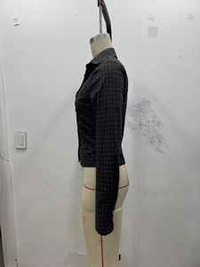 Detail of slim-fit dark grey plaid long-sleeve shirt with ruched texture on mannequin