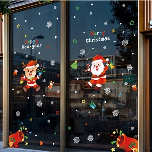 Christmas window decals with Santa, reindeer and snowflakes on a shop glass front