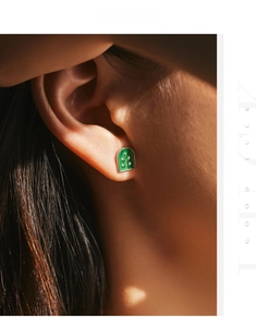 Detail view of model wearing a green enamel leaf plant badge stud earring in gold finish