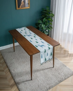 Detail of blue-grey table runner with reindeer motifs and decorative tassels