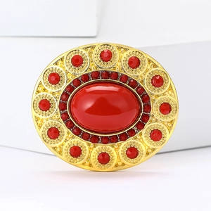 Elegant vintage gold oval brooch with large red crystal and rhinestone accents