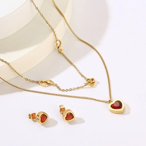 Detail of gold double-layer necklace and red heart crystal earrings jewelry set