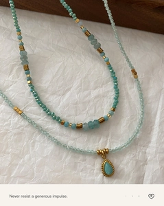 Macro shot of layered mint green Amazonite beaded necklaces with a teardrop pendant