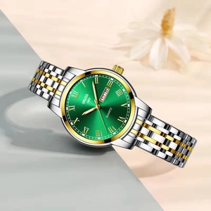 Quartz watch with green dial, two-tone gold and silver strap, and Roman numerals