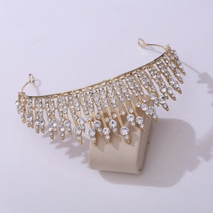 Detail of luxury gold fringe bridal crown with sparkling crystal rhinestones on stand