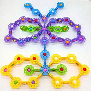 Detail of colorful gear-shaped building blocks assembled into creative butterfly designs