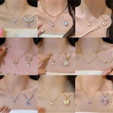 Collage showing various minimalist butterfly and pearl pendants on fine steel necklaces