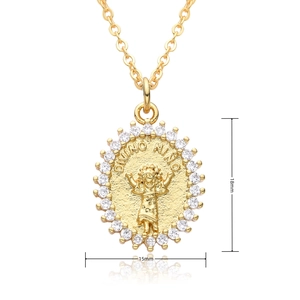 Detail view of 18k gold plated Divino Nino pendant with zircon stones and 18mmx15mm size labels