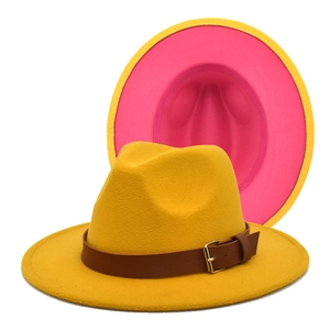 Close-up of vibrant yellow wool felt fedora with pink contrast brim and leather strap