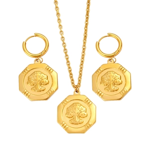 Golden jewelry set featuring a tree of life necklace and matching hexagonal hoop earrings