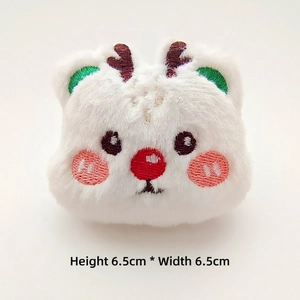 Close-up of white plush Christmas bear accessory with embroidery detail, 6.5cm x 6.5cm
