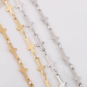 Close-up of interlocking metal cross link chains in polished gold and silver finishes