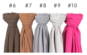 Detail view of five solid color pearl chiffon scarves with fine texture and rolled edges