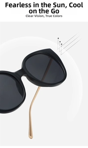 Close-up of oversized sunglasses featuring black frames and slim gold metal temples