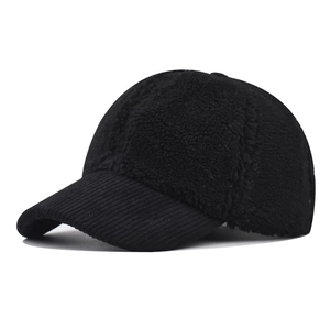 Close-up of black baseball cap showing texture of lamb wool and corduroy brim detail