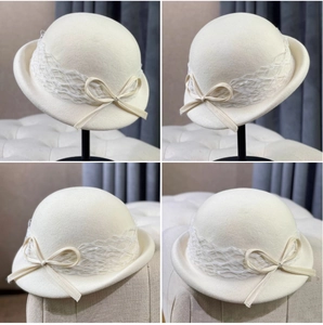 Detail of white wool cloche hat featuring elegant lace ribbon and delicate bow accent