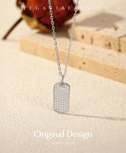 Macro shot of rectangular silver pendant with micro-paved cubic zirconia on a minimalist chain
