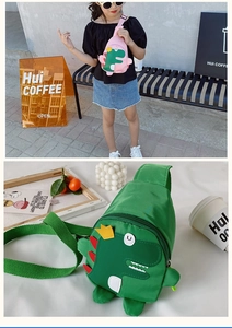 Detailed view of pink and green nylon dinosaur crossbody bags for kids with adjustable straps