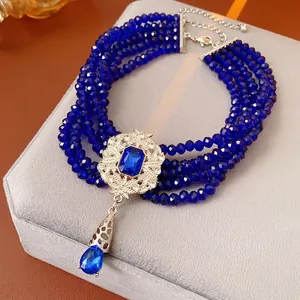 Vintage multi-layer dark blue beaded necklace with silver floral pendant and teardrop gem