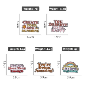 Detail of colorful enamel lapel pins with inspirational quotes and dimensions