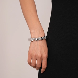 Close-up of a silver polished lava texture irregular cuff bracelet on model wrist