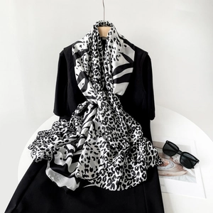 Stylish leopard print silk scarf with black and white splice tied on a black dress