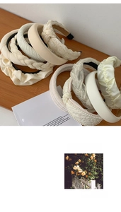 Detailed close-up of cream-colored headband set featuring woven fabrics and pearls