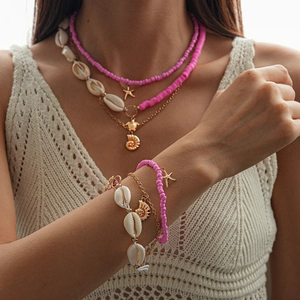 Detail view of Bohemian seashell and starfish multi-layer necklace with pink beads