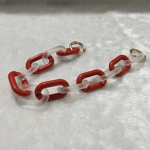 Acrylic chain strap with alternating red and frosted links and golden metal rings